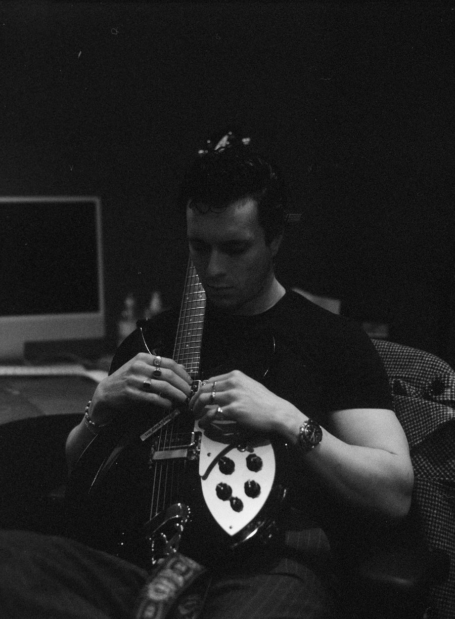 Ollie - looking at his guitar